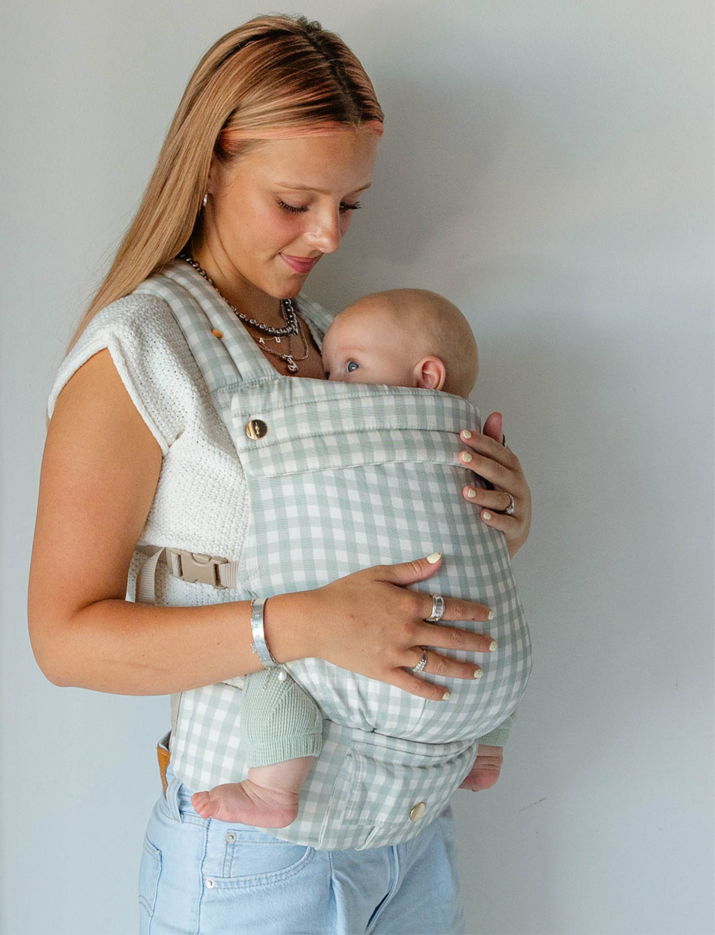 Coco Carriers Coco Gingham baby carrier with a front pocket, showing soft fabric and adjustable straps for comfortable carrying.