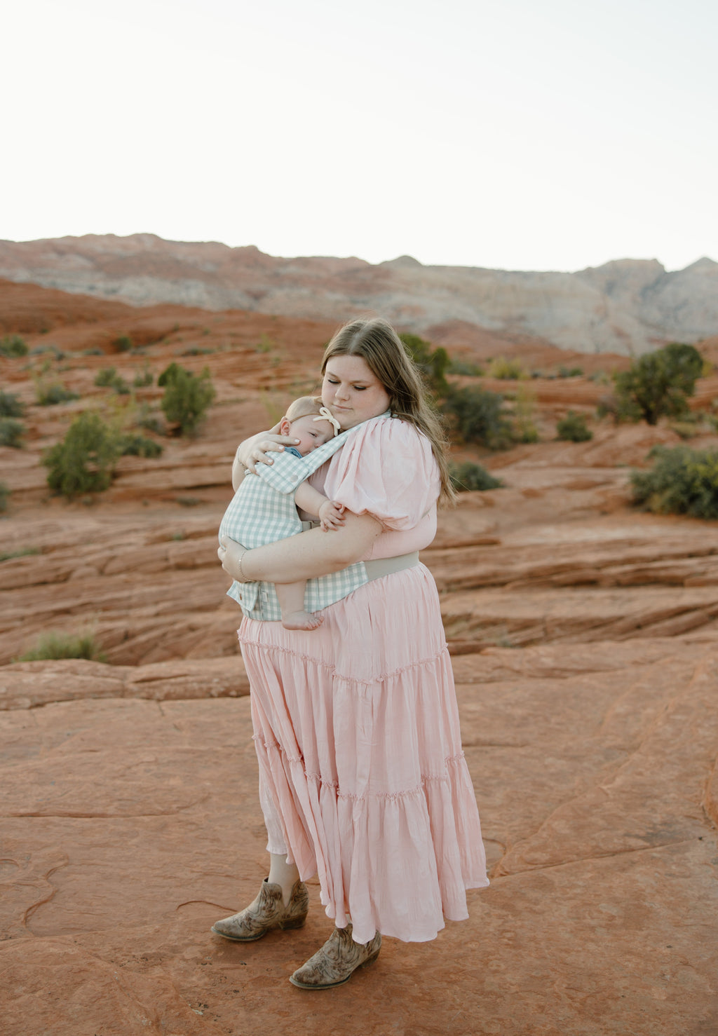 Coco Gingham baby carrier by Coco Carriers with a front pocket, adjustable straps, and supportive design for comfortable carrying.