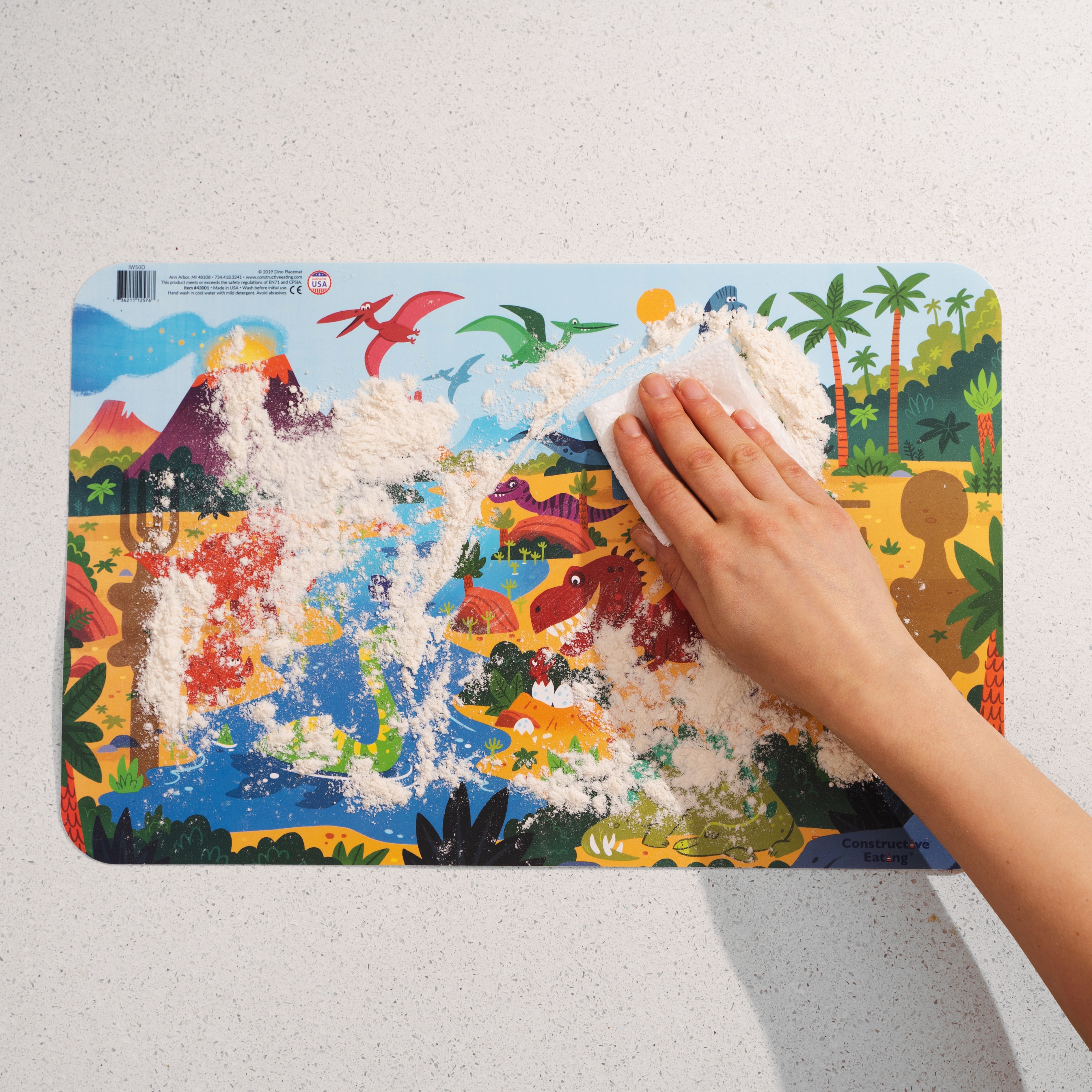 Constructive Eating DinoPlacemat eating set with wipe-clean surface, featuring colorful dinosaur illustrations for kids.