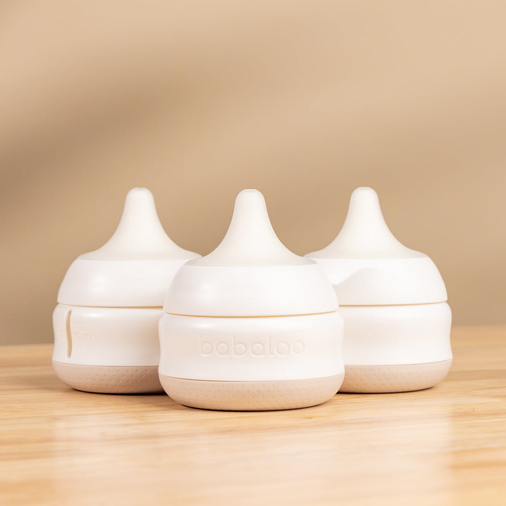 Set of three Babaloo baby bottles with colorful caps, made of BPA-free plastic, suitable for feeding infants.