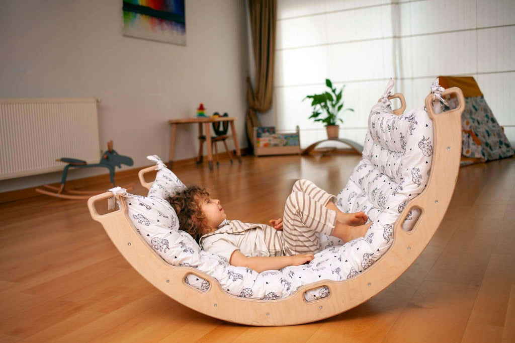 Kidodido climbing arch and rocker with origami pattern pillow, featuring a colorful, cushioned play structure for kids.