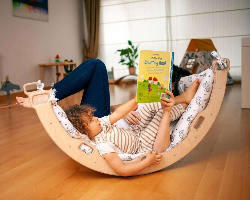 Kidodido climbing arch and rocker with origami pattern pillow, colorful foam structure for indoor play and motor skill development.